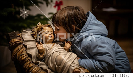 A boy kissing a nativity statue tenderly. A boy kissing a nativity statue tenderly. 131333952