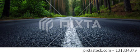 Empty road leading through a tranquil forest. 131334379