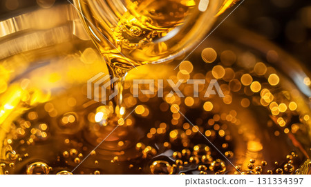Honey pouring, golden bubbles glistening. 131334397