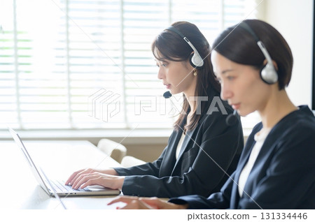 Women working in a call center Women working in a call center 131334446