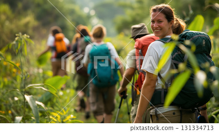 Hiker smiling over shoulder on a trail. Hiker smiling over shoulder on a trail. 131334713