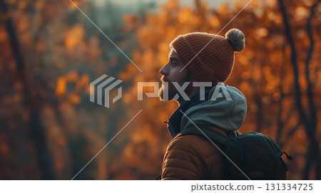 Man in beanie enjoying autumn outdoors. 131334725