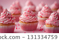 Pink frosted cupcakes with sprinkles. 131334759