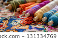 Colorful threads on spools with woven background. 131334769