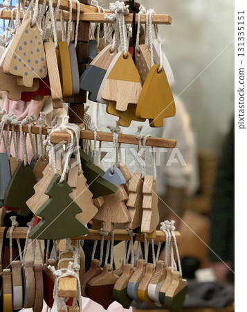 Christmas tree ornaments on display at a holiday market, perfect for festive backgrounds 131335151