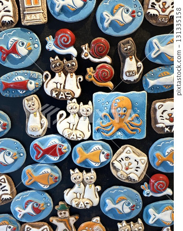 Colorful animal themed magnets displayed on a black surface background Colorful animal themed magnets displayed on a black surface background 131335158
