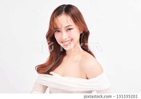 A beautiful young Asian woman with clean, fresh skin against a white background. Skincare, facial treatment, cosmetology, beauty, and spa. An elegant portrait of an Asian woman. A beautiful young Asian woman with clean, fresh skin against a white background. Skincare, facial treatment, cosmetology, beauty, and spa. An elegant portrait of an Asian woman. 131335201