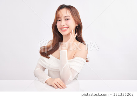 A beautiful young Asian woman with clean, fresh skin against a white background. Skincare, facial treatment, cosmetology, beauty, and spa. An elegant portrait of an Asian woman. A beautiful young Asian woman with clean, fresh skin against a white background. Skincare, facial treatment, cosmetology, beauty, and spa. An elegant portrait of an Asian woman. 131335202