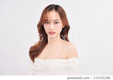A beautiful young Asian woman with clean, fresh skin against a white background. Skincare, facial treatment, cosmetology, beauty, and spa. An elegant portrait of an Asian woman. A beautiful young Asian woman with clean, fresh skin against a white background. Skincare, facial treatment, cosmetology, beauty, and spa. An elegant portrait of an Asian woman. 131335206