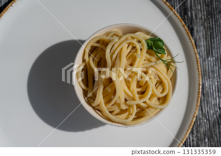 A plate of boiled spaghetti in a cafe.  131335359
