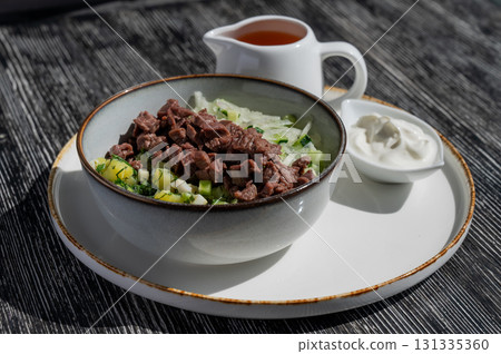 Okroshka with beef on kvass in a cafe. Okroshka with beef on kvass in a cafe. 131335360