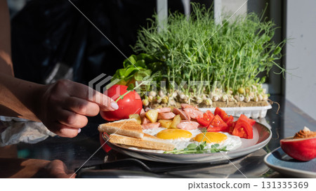 Chef serves fried eggs in a cafe. Chef serves fried eggs in a cafe. 131335369