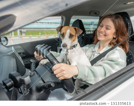 Caucasian woman traveling by car with her dog. Caucasian woman traveling by car with her dog. 131335613