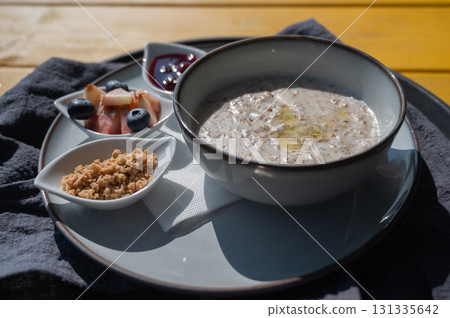 Reserved breakfast at a cafe. A plate of porridge on a table in a street cafe.  131335642