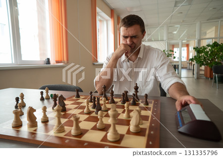 A man switches a chess clock. A man switches a chess clock. 131335796