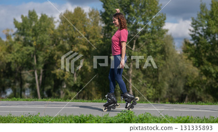 Caucasian woman roller skating in park. Caucasian woman roller skating in park. 131335893