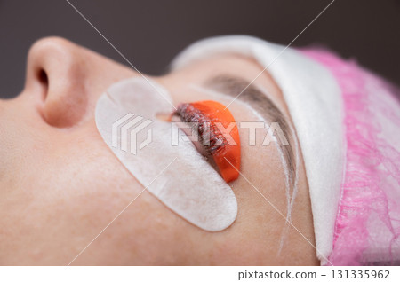 The process of professional lamination and tinting of eyelashes in the salon. The process of professional lamination and tinting of eyelashes in the salon. 131335962