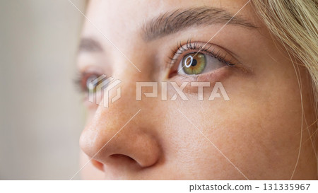 Close-up portrait of a woman after eyelash lamination procedure. Close-up portrait of a woman after eyelash lamination procedure. 131335967