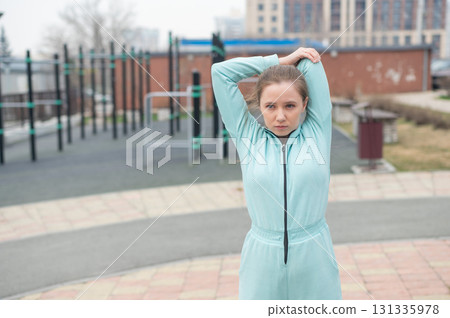 Young woman doing fitness outdoors.  131335978