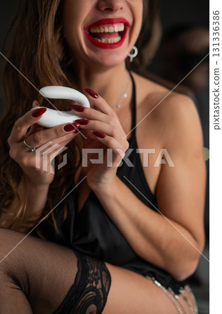 Beautiful brunette in lingerie holds curved vibrator. Beautiful brunette in lingerie holds curved vibrator. 131336386