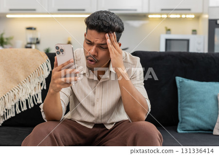 Indian man loses mobile game makes facepalm taps try again aims for revenge focuses on next attempt 131336414