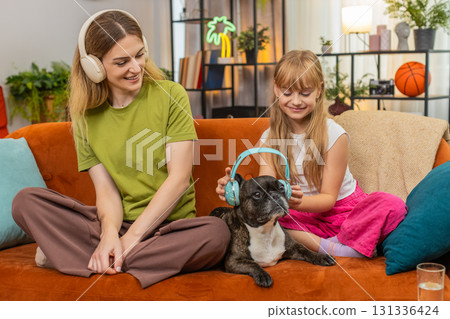 Mother daughter dog wireless headphones lo fi music work on laptop hum sing rhythm with focus family Mother daughter dog wireless headphones lo fi music work on laptop hum sing rhythm with focus family 131336424