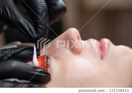 Caucasian woman undergoing eyelash lamination procedure.  131336433