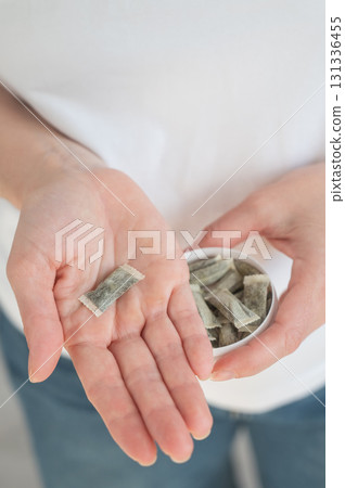 A woman holds a jar of chewing tobacco. A woman holds a jar of chewing tobacco. 131336455