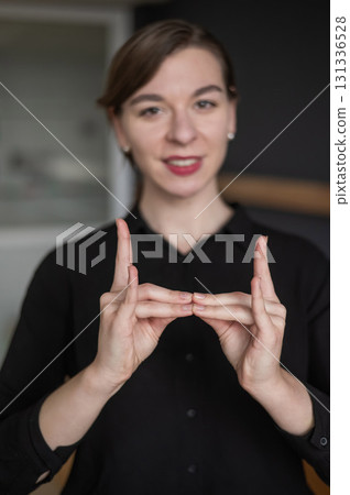 Woman showing the words hostel and bed in sign language. Woman showing the words hostel and bed in sign language. 131336528