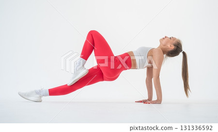 Caucasian woman doing sports exercises on white background.  131336592