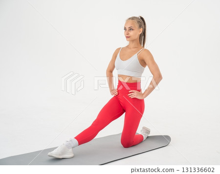 Young woman doing splits exercises on white background. 131336602