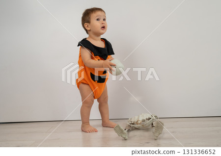 Cute Caucasian boy in pumpkin costume for Halloween. Cute Caucasian boy in pumpkin costume for Halloween. 131336652