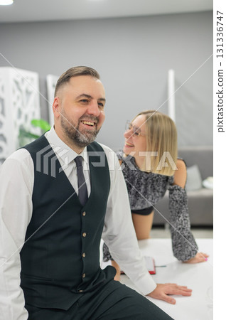 Colleagues fooling around at work in the office.  131336747