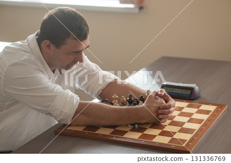 Middle aged Caucasian man playing chess. Middle aged Caucasian man playing chess. 131336769