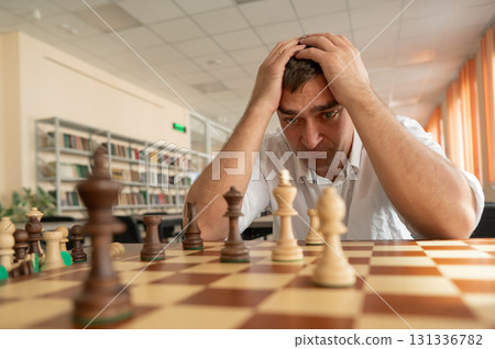 Middle aged Caucasian man playing chess. Middle aged Caucasian man playing chess. 131336782