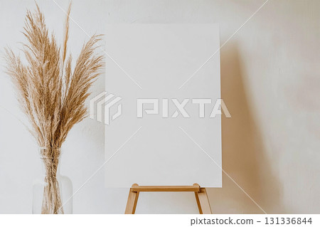 Minimalist blank wedding sign mockup on an easel with dried floral decor. Minimalist blank wedding sign mockup on an easel with dried floral decor. 131336844