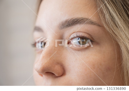 Close-up portrait of a woman after eyelash lamination procedure. Close-up portrait of a woman after eyelash lamination procedure. 131336890