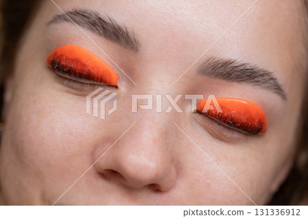 Caucasian woman undergoing eyelash lamination procedure. top view.  131336912