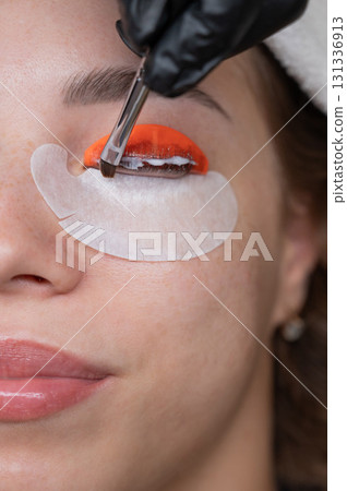 Caucasian woman undergoing eyelash lamination procedure.  131336913