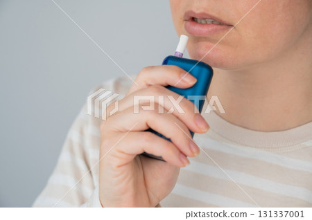 Caucasian woman smoking electronic cigarette. Tobacco heating system. Caucasian woman smoking electronic cigarette. Tobacco heating system. 131337001