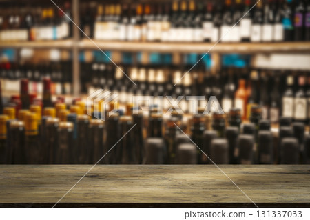 Wine wooden table background. Blurred wine shop with bottles on the counter.  131337033
