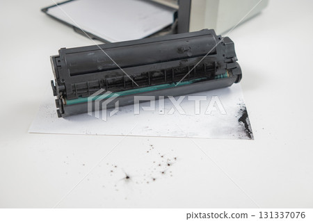 Broken laser printer cartridge on white background. Broken laser printer cartridge on white background. 131337076