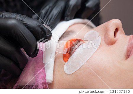 Caucasian woman undergoing eyelash lamination procedure. Caucasian woman undergoing eyelash lamination procedure. 131337120