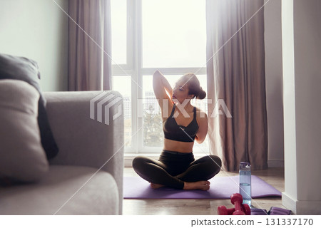 Woman training at home, girl doing exercises. 131337170