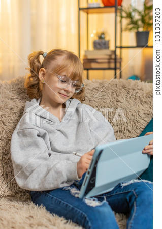 Young teenager girl drawing on tablet with stylus at home sofa digital art cheerful final result Young teenager girl drawing on tablet with stylus at home sofa digital art cheerful final result 131337203