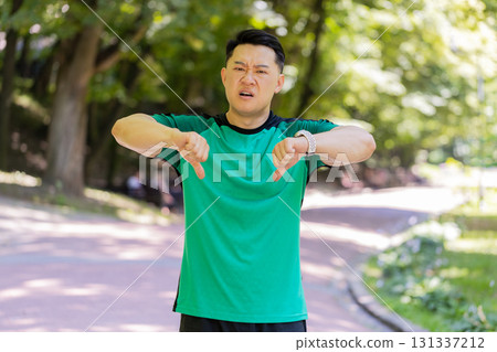 Upset sportsman showing thumbs down dislike gesture expressing discontent disapproval dissatisfied Upset sportsman showing thumbs down dislike gesture expressing discontent disapproval dissatisfied 131337212