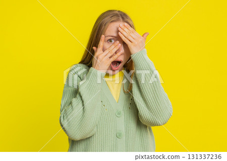 Curious mature woman closing eyes with hands and spying through fingers, hiding and peeping Curious mature woman closing eyes with hands and spying through fingers, hiding and peeping 131337236