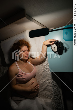 Pregnant woman suffers from pain at night.  131337267