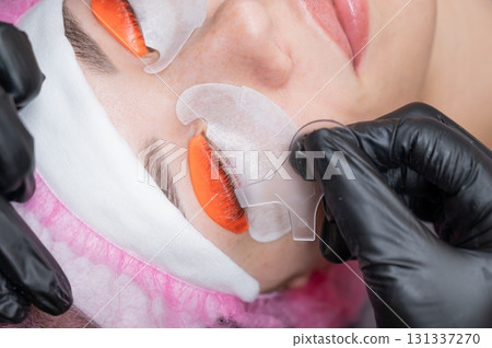 Caucasian woman undergoing eyelash lamination procedure.  131337270