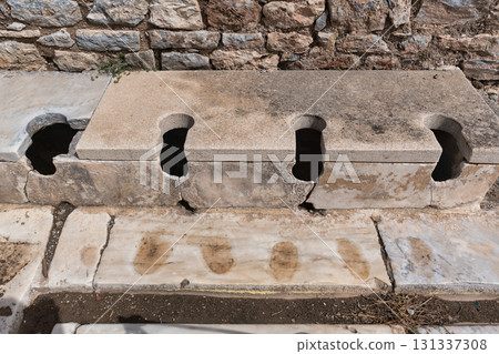 Stone seats of the Ancient Roman Public Latrines, Ephesus Archaeological Site, Selcuk, Turkey Stone seats of the Ancient Roman Public Latrines, Ephesus Archaeological Site, Selcuk, Turkey 131337308